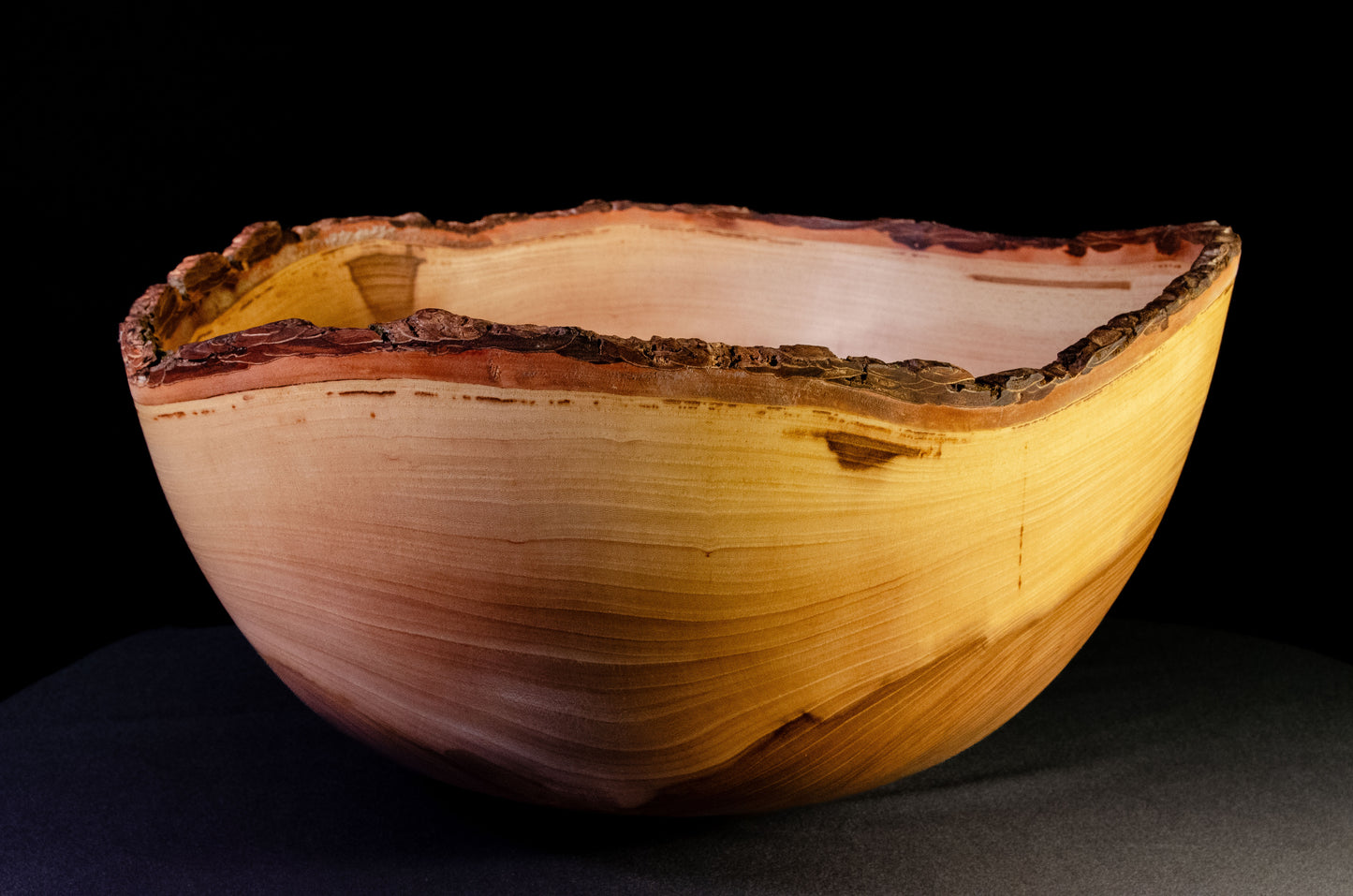 Large bowl with warm grain and bark-on natural edge. This is a family style serving bowl that would make for a stunning centerpiece or other decorative gift.