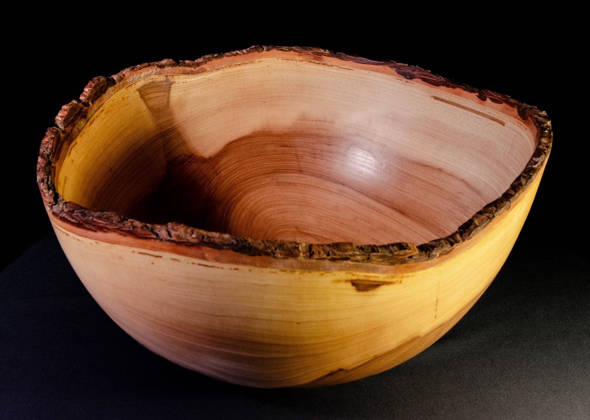 Large bowl with warm grain and bark-on natural edge. This is a family style serving bowl that would make for a stunning centerpiece or other decorative gift.