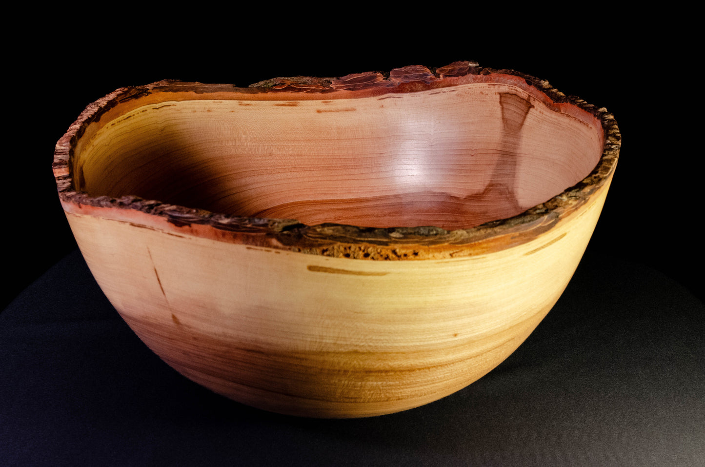 Large bowl with warm grain and bark-on natural edge. This is a family style serving bowl that would make for a stunning centerpiece or other decorative gift.