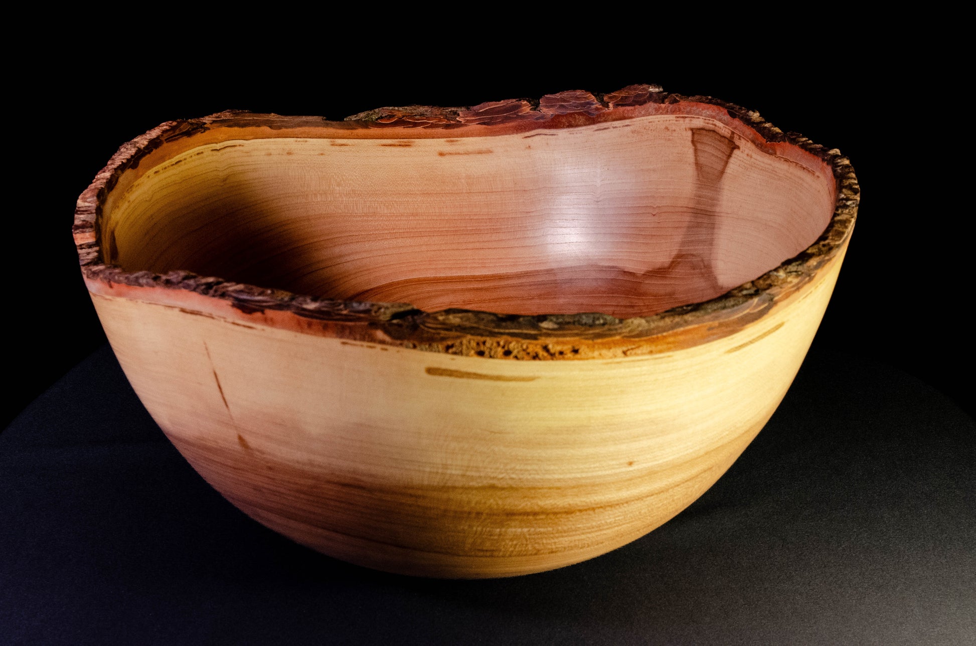 Large bowl with warm grain and bark-on natural edge. This is a family style serving bowl that would make for a stunning centerpiece or other decorative gift.