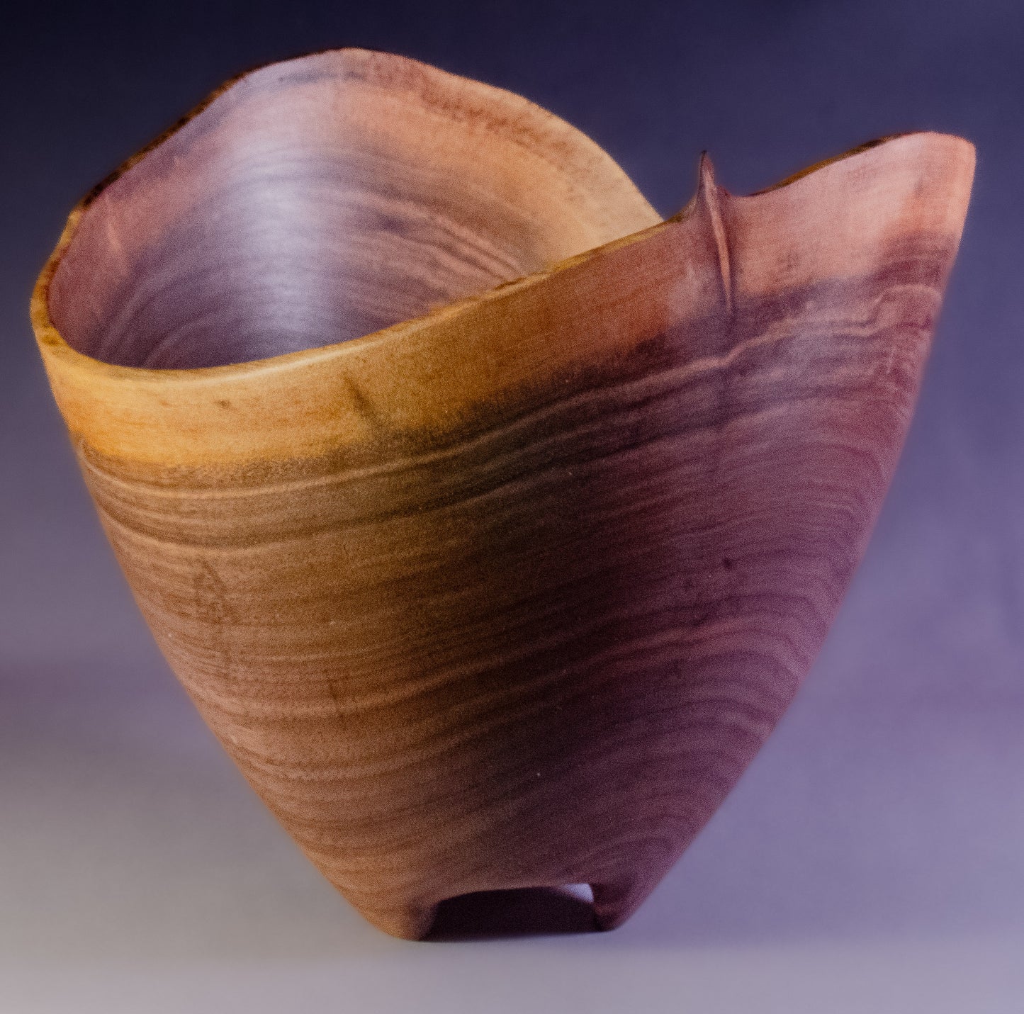 Black walnut bowl wth natural edge and carved feet