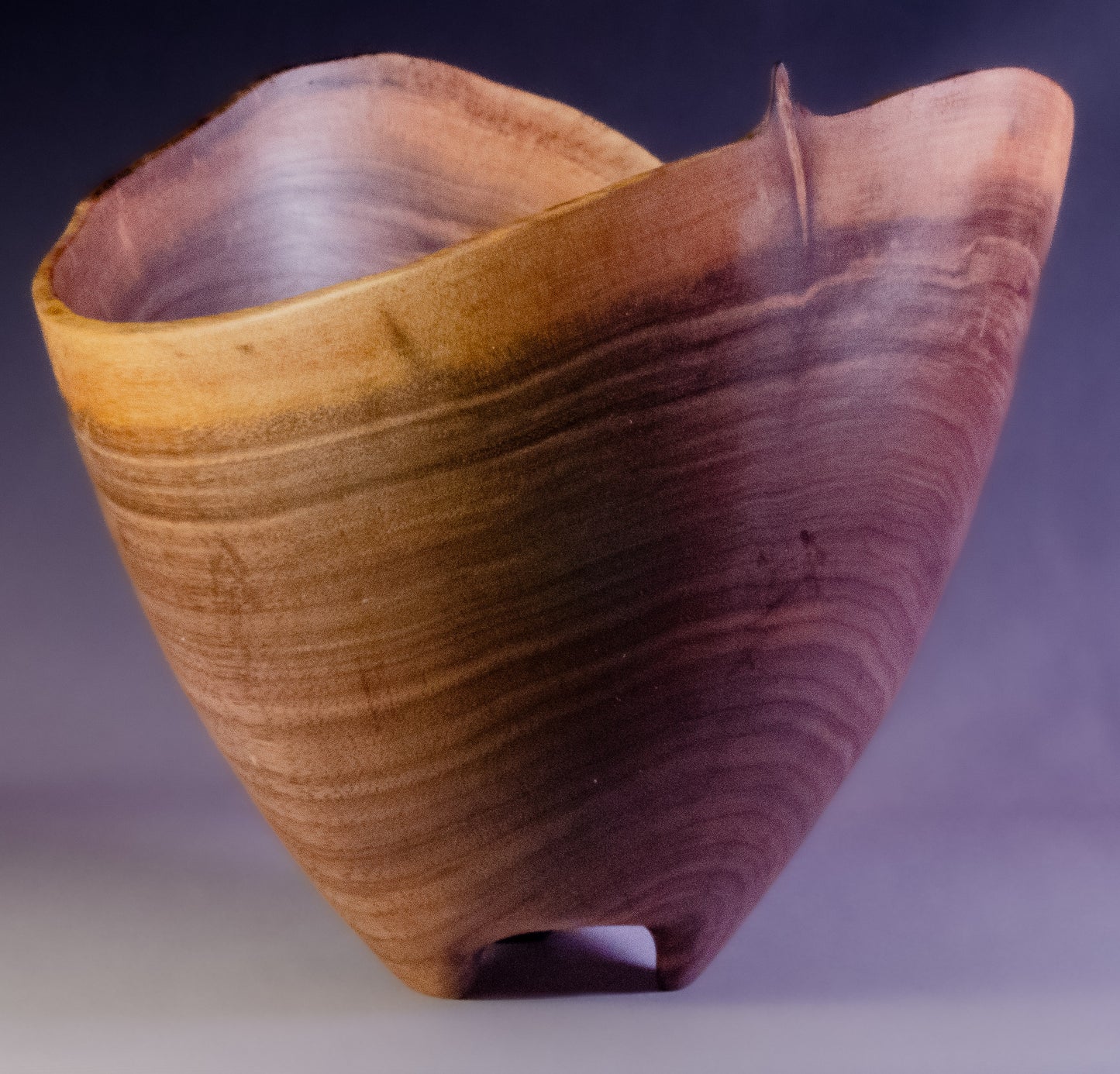 Black walnut bowl wth natural edge and carved feet