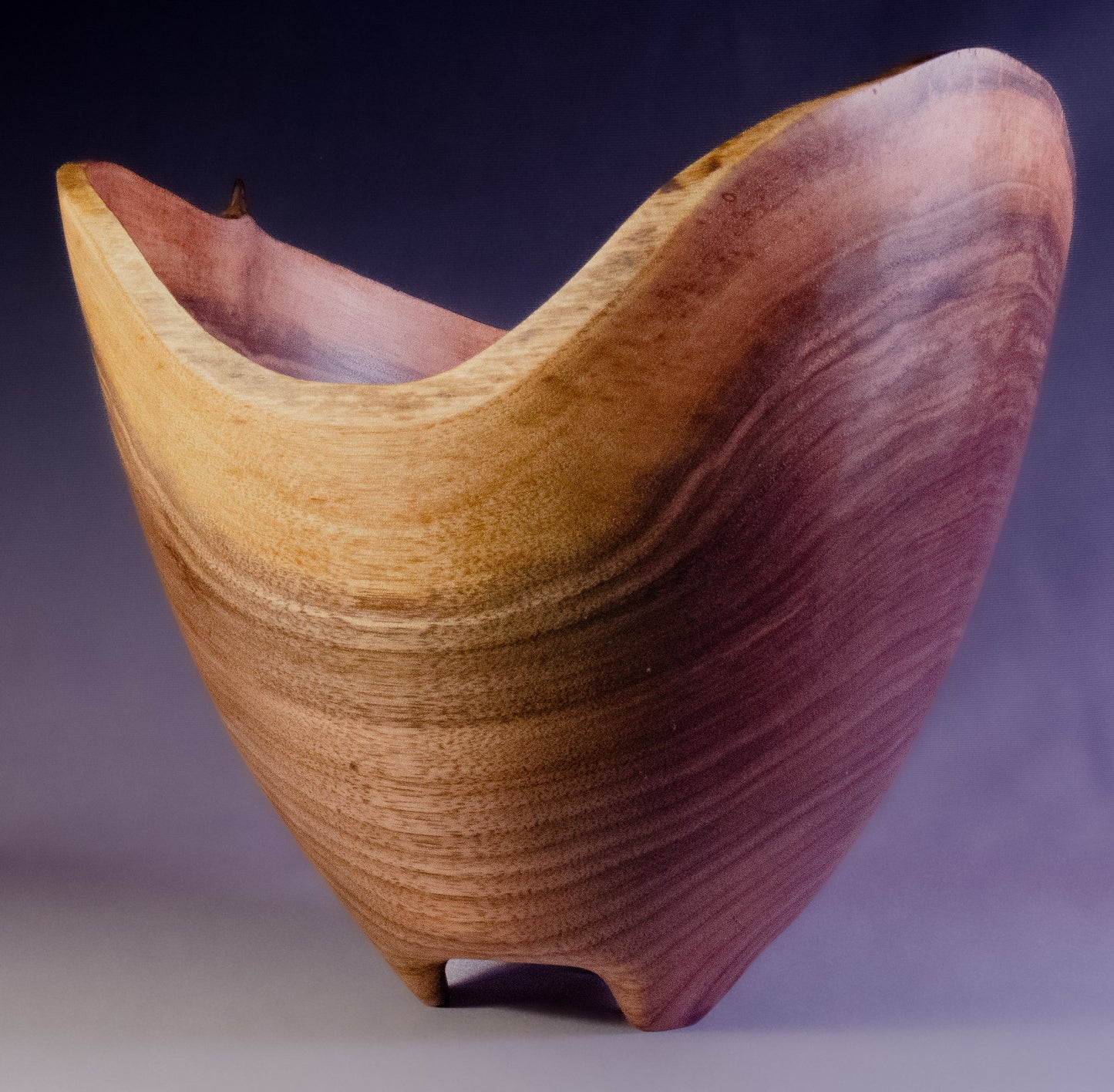 Black walnut bowl wth natural edge and carved feet