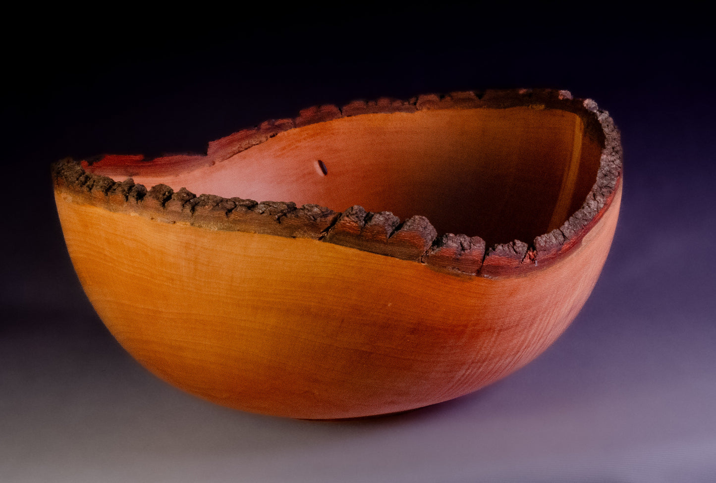 Maple bowl with feathering and natural edge