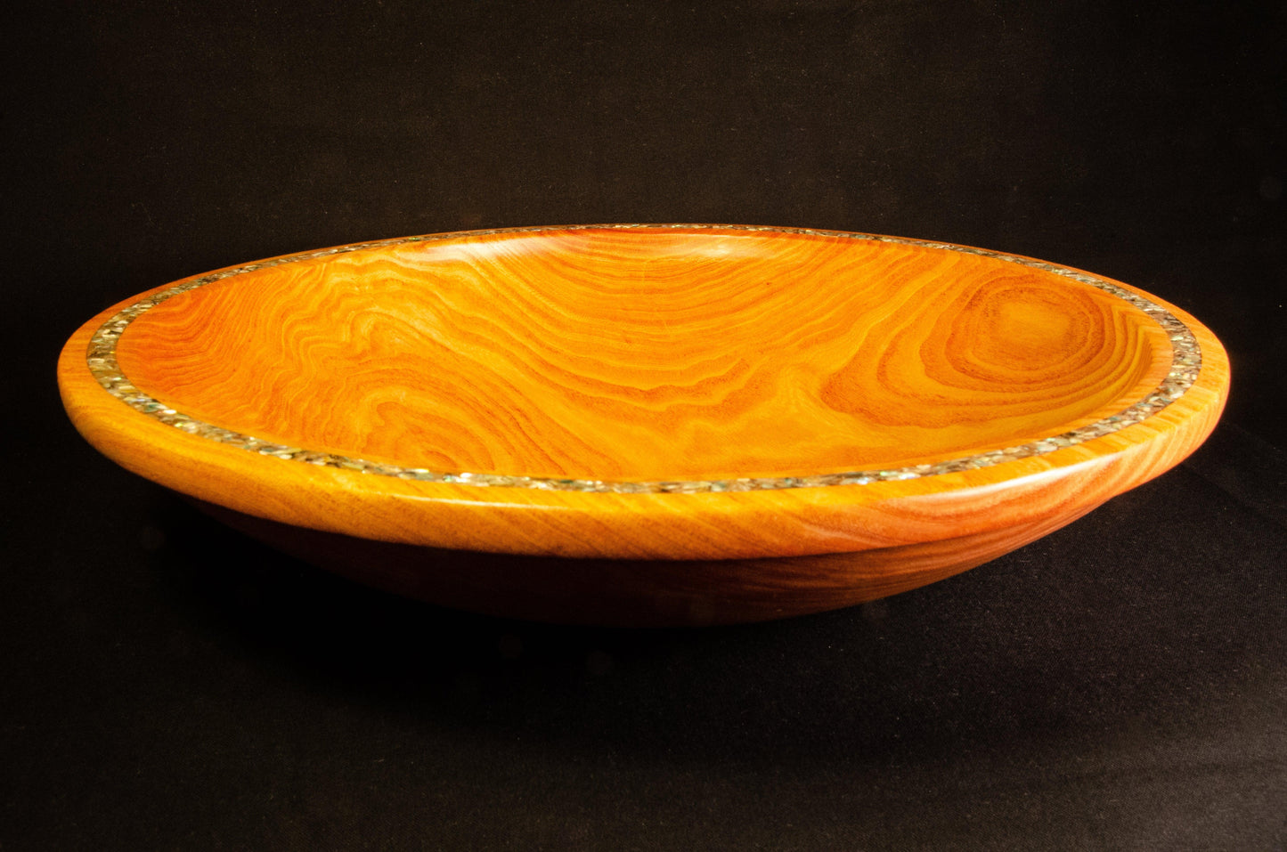 Honey Locust Platter. Dramatic edge feature with abalone shell adds sparkle to a strongly figured platter.