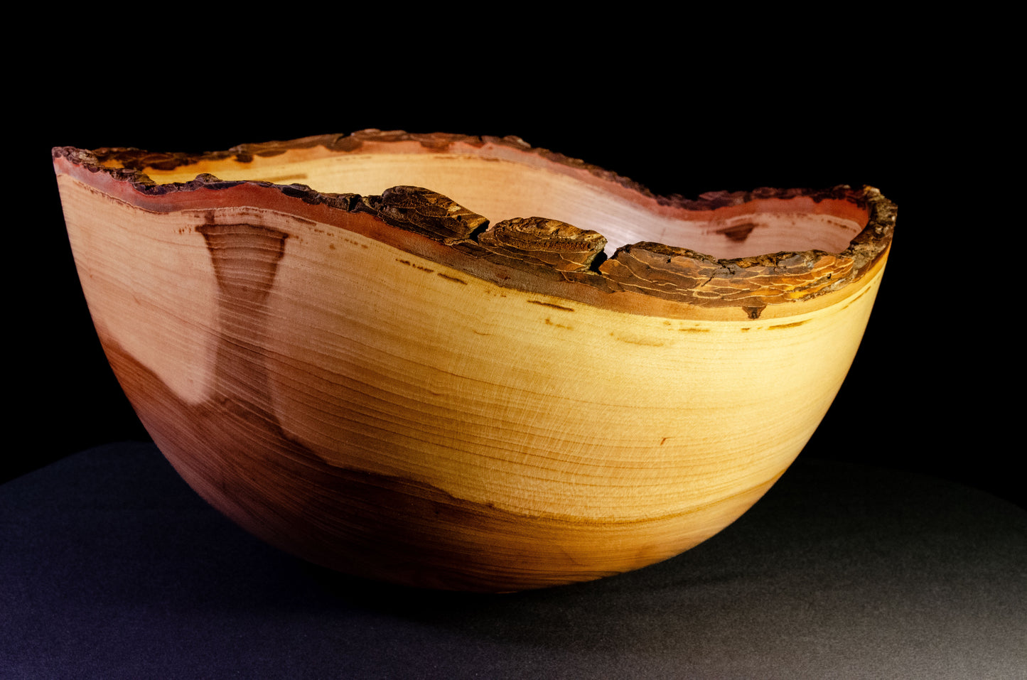 Large bowl with warm grain and bark-on natural edge. This is a family style serving bowl that would make for a stunning centerpiece or other decorative gift.