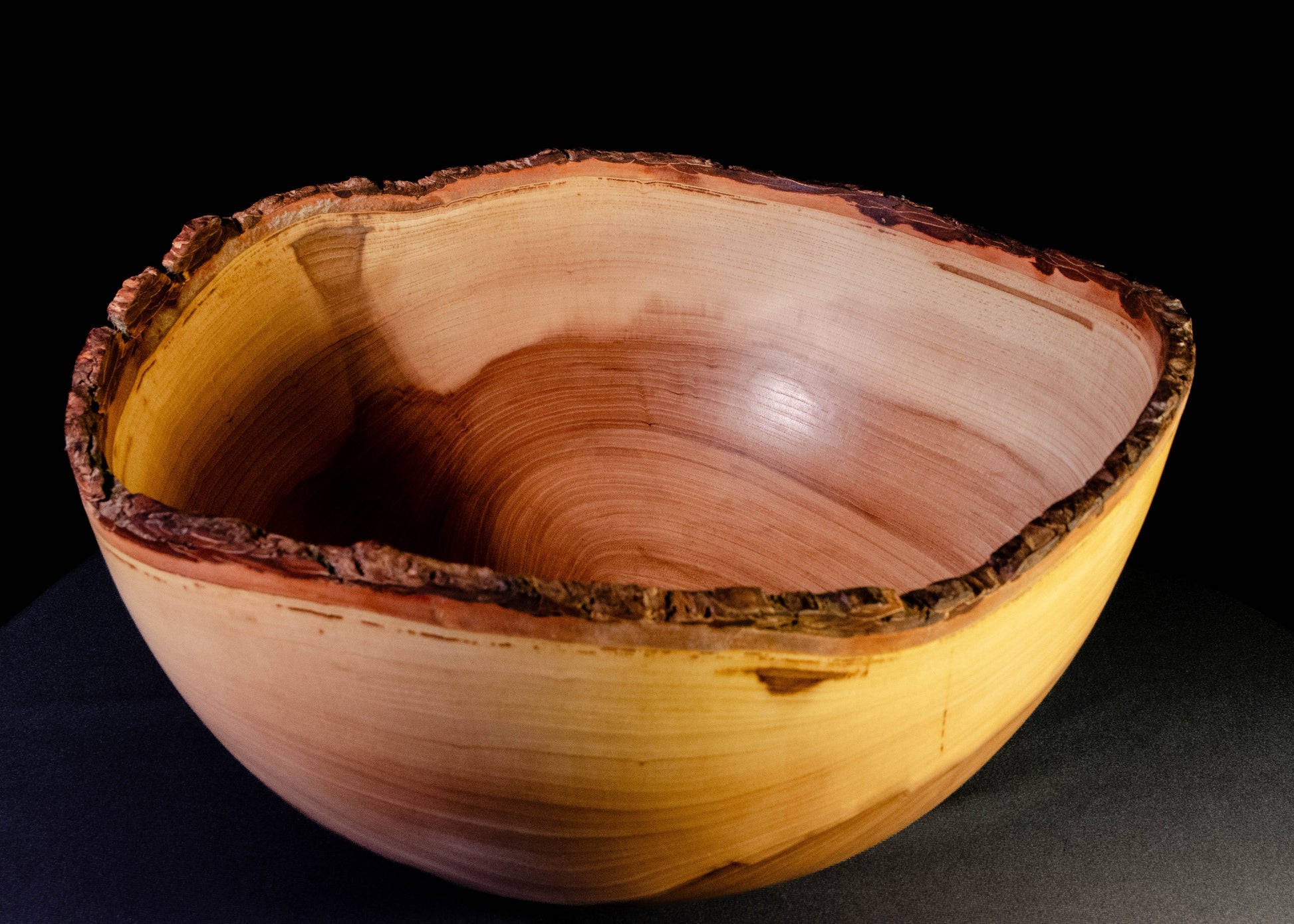 Large bowl with warm grain and bark-on natural edge. This is a family style serving bowl that would make for a stunning centerpiece or other decorative gift.