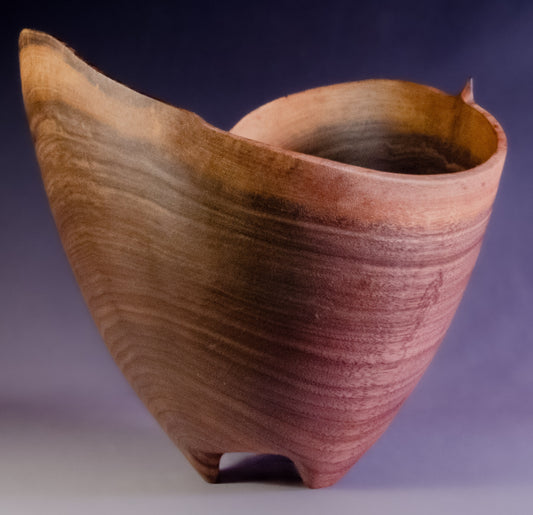 Black walnut bowl wth natural edge and carved feet