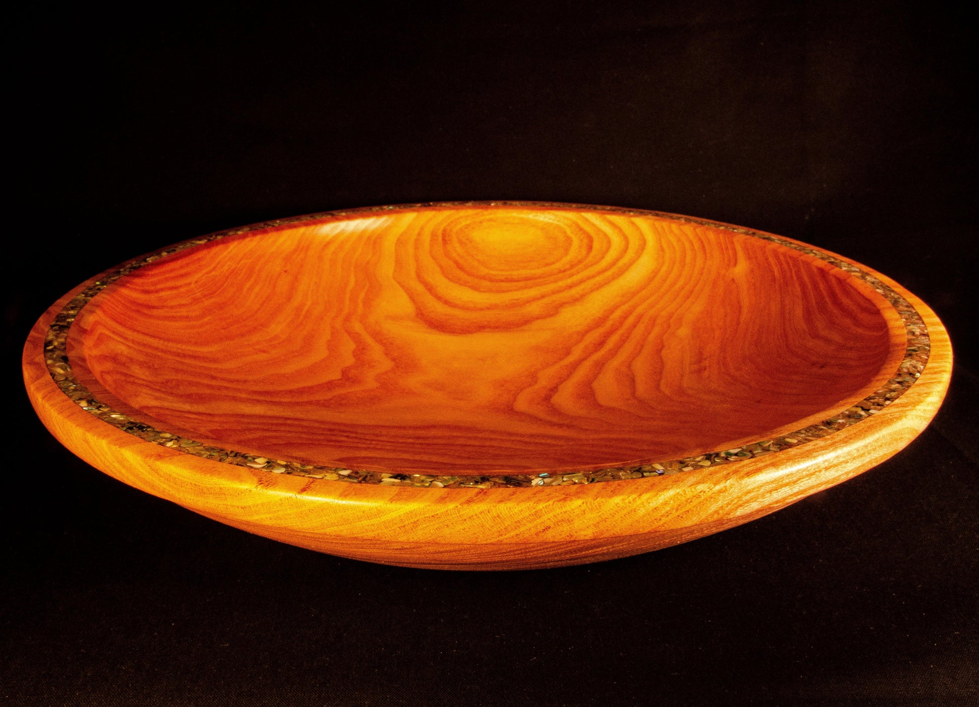 Honey Locust Platter. Dramatic edge feature with abalone shell adds sparkle to a strongly figured platter.